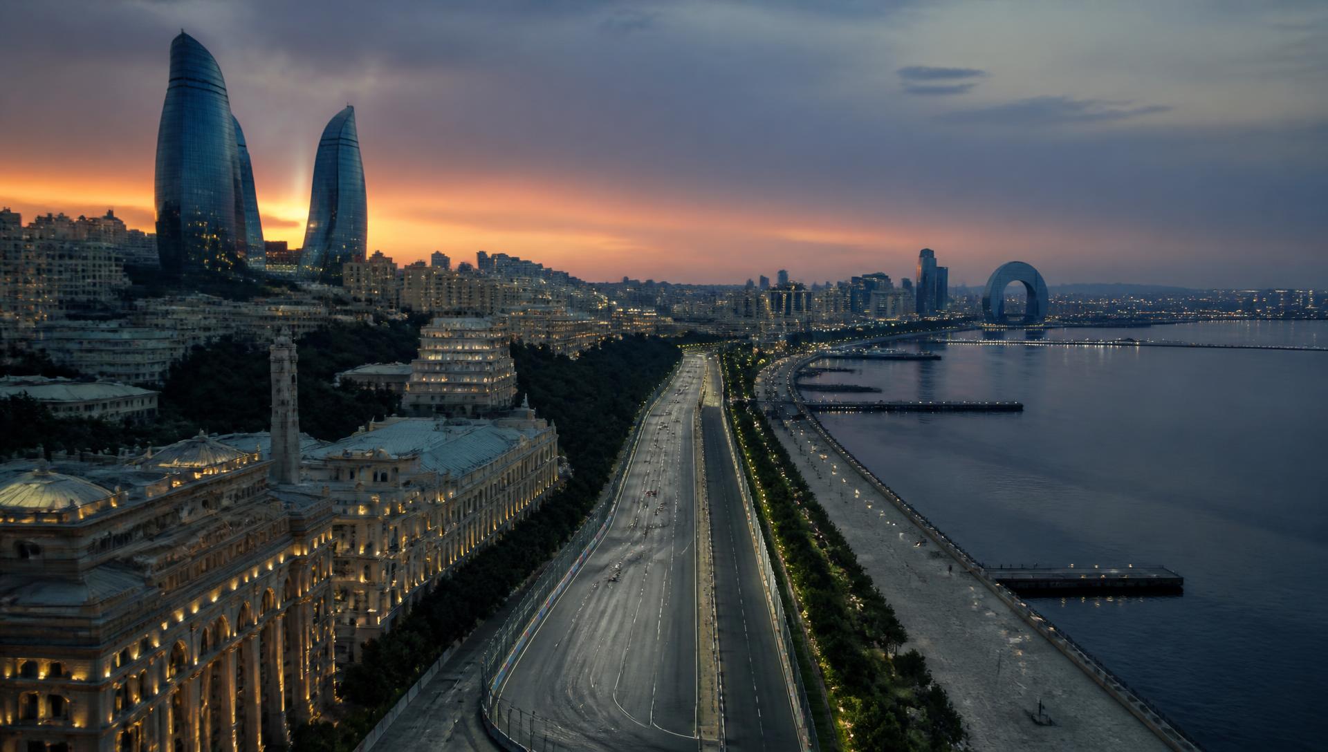 Aerial view of a wide seafront street circuit running through Baku at dusk