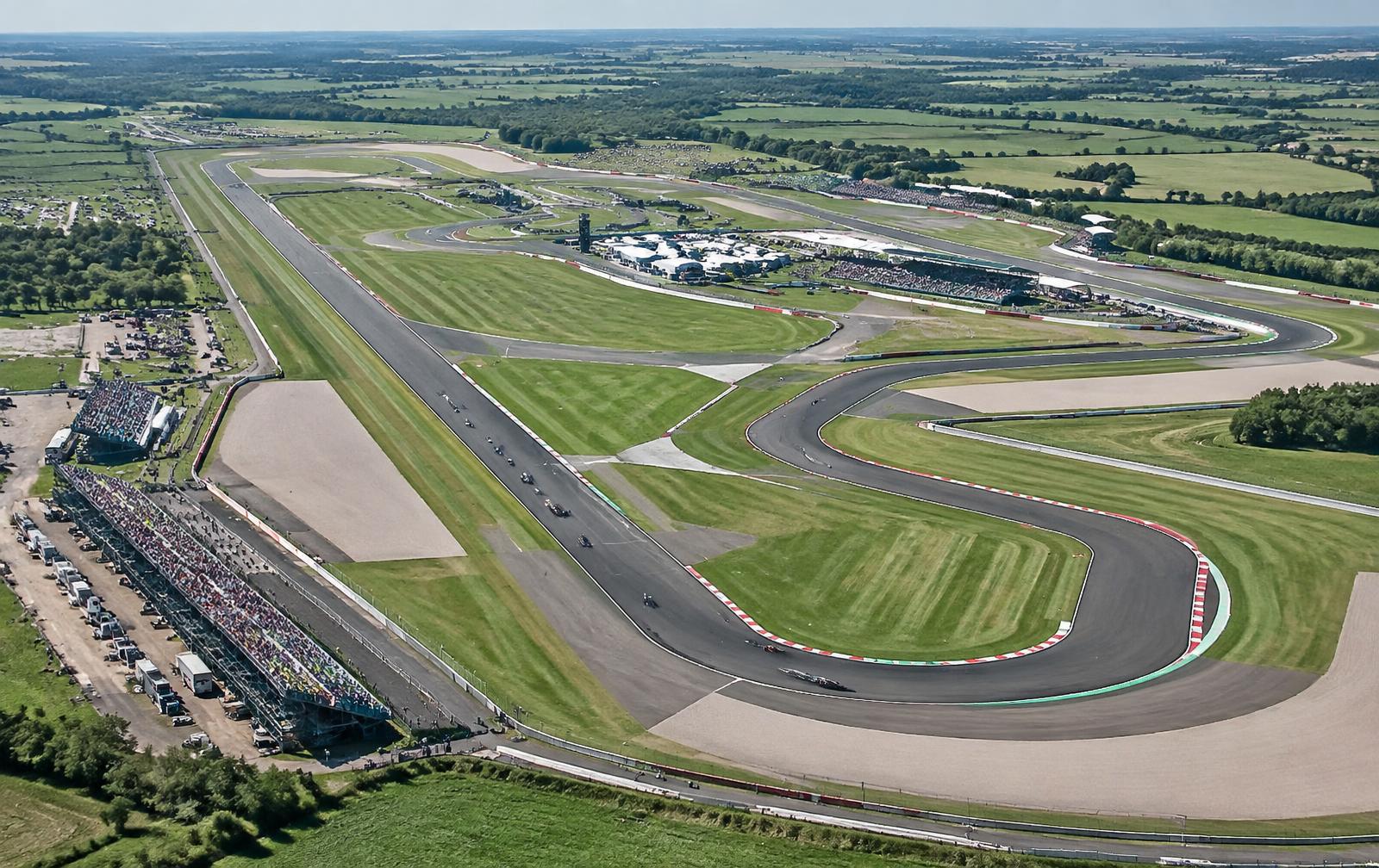 Aerial view of a wide English race circuit on former airfield land