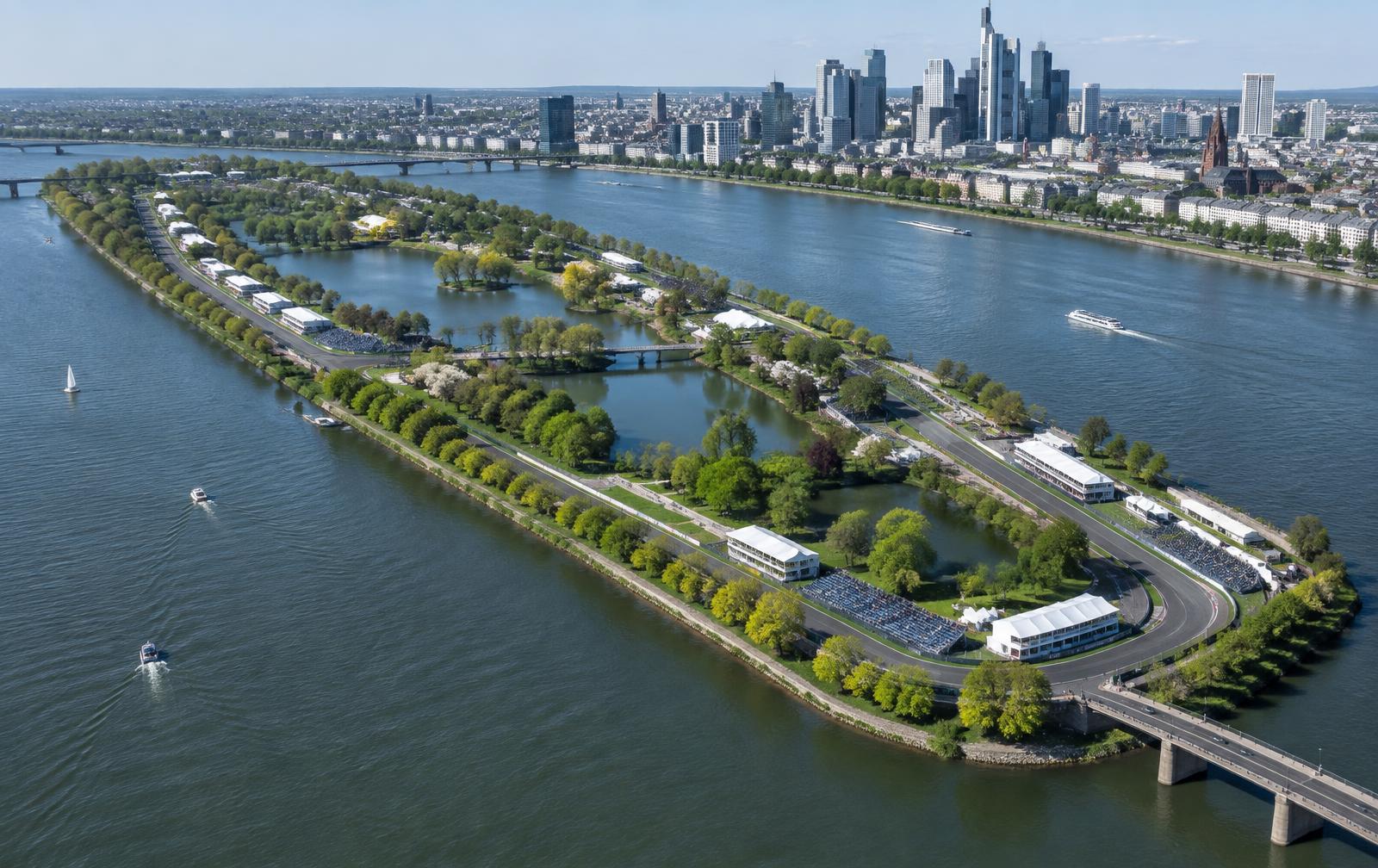 Aerial view of a river island park circuit beside a city skyline