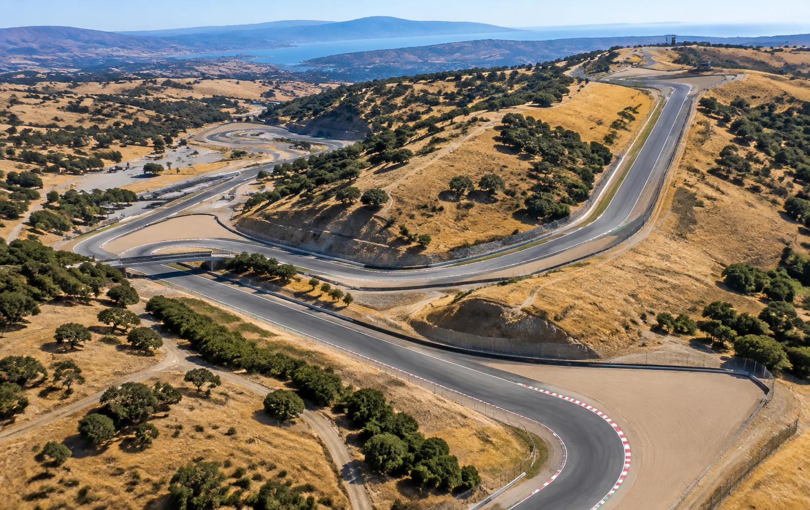 Aerial view of a hillside race circuit winding through dry golden hills