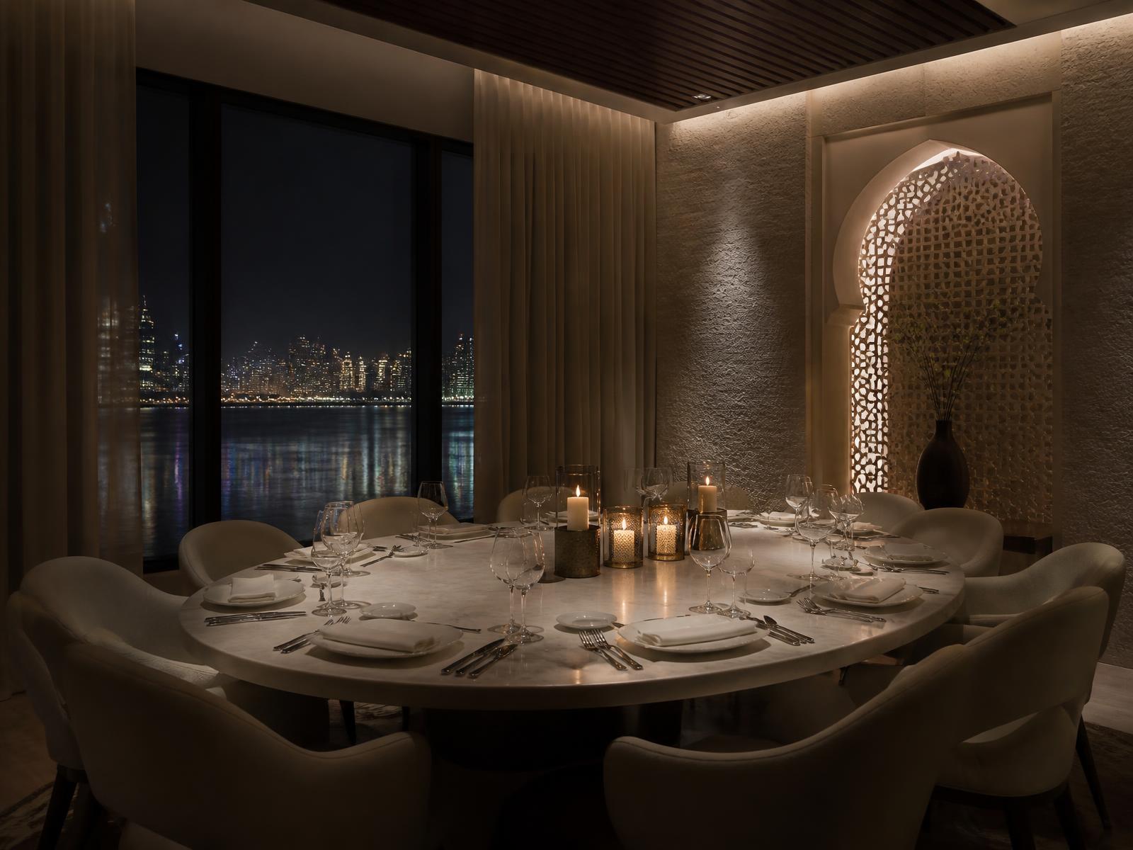 Private dining room set for dinner with a waterfront city view at night