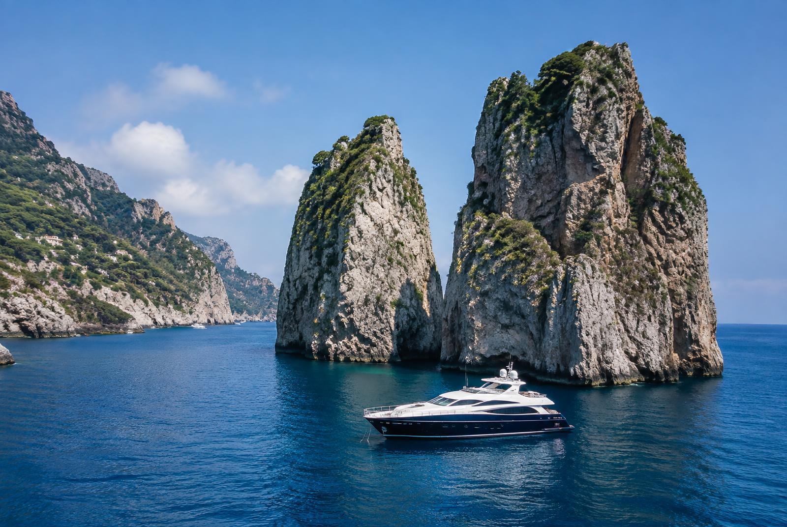 Yacht anchored beside the Faraglioni rocks off Capri