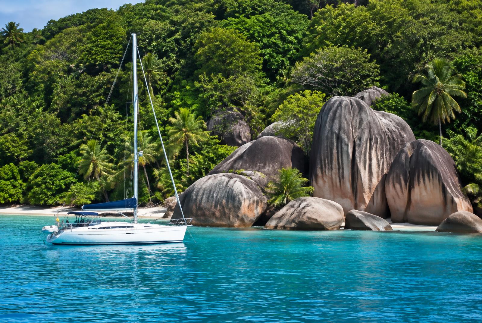 Yacht anchored beside granite boulders in the Seychelles